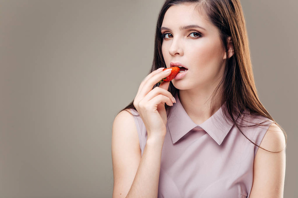 Sexy Woman Eating Strawberry. Sensual Lips. Manicure and Lipstick. Desire - Фото, изображение