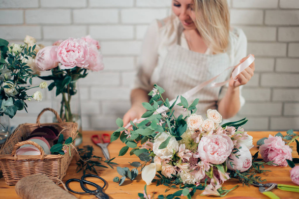 Florist at work: woman making fashion modern bouquet of different flowers - Fotoğraf, Görsel