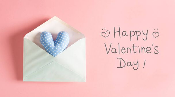 Valentines Day message with a blue heart cushion - 写真・画像