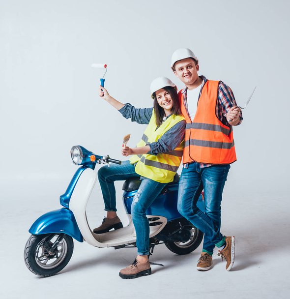 Happy young couple on motorbike. Shopping for the construction and repair for new home concept. - Foto, immagini