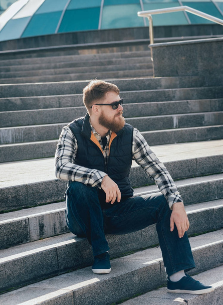 Handsome bearded man in casual clothes posing on camera. - Foto, afbeelding