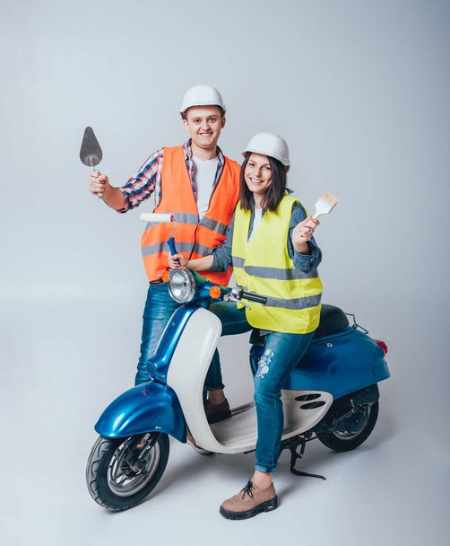 Happy young couple on motorbike. Shopping for the construction and repair for new home concept. - Foto, imagen