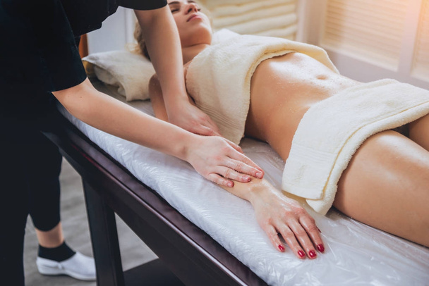 Beautiful woman in spa salon getting body massage - Фото, зображення