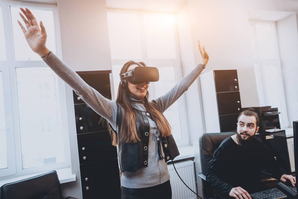 Young man with woman creative office workers testing VR goggles and having fun - Valokuva, kuva