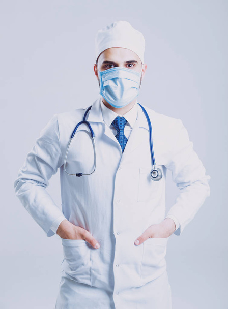 Young brown eyed doctor or intern against white wall - Photo, Image