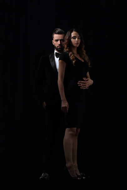 elegant man and woman posing next to each other on studio. - Foto, immagini
