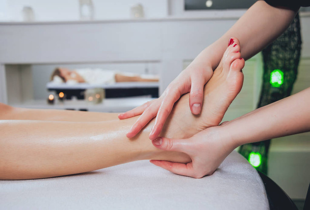 Cropped image of woman relaxing in the spa. Foot massage. - Valokuva, kuva