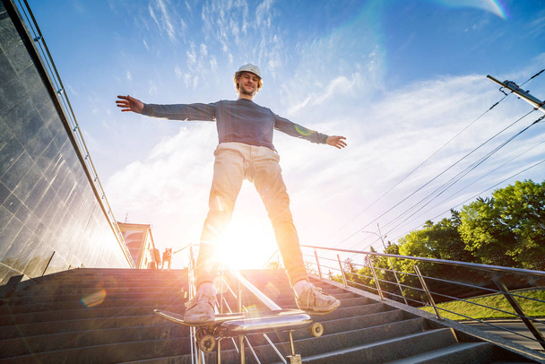 Skateboarder practicing and jumping on the streets - 写真・画像
