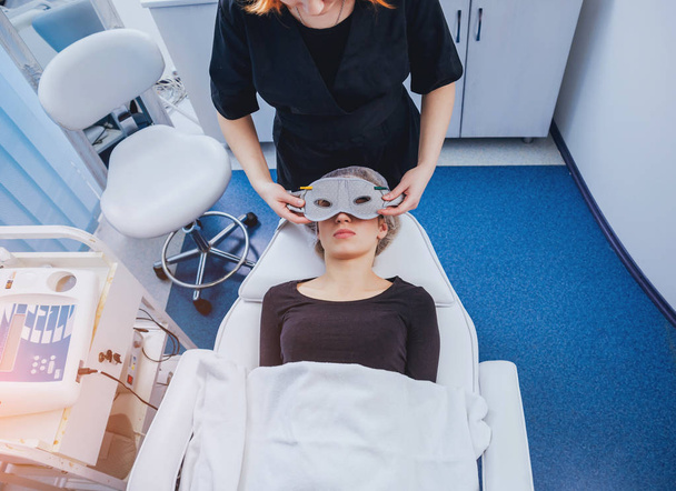 Young woman in spa salon. Cosmetic medicine. Mesotherapy. Medical devices. - Fotó, kép