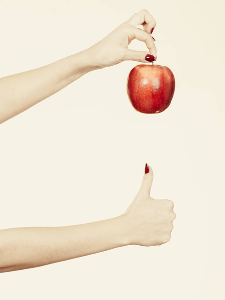 Woman hand holding delicious red apple - Foto, Bild