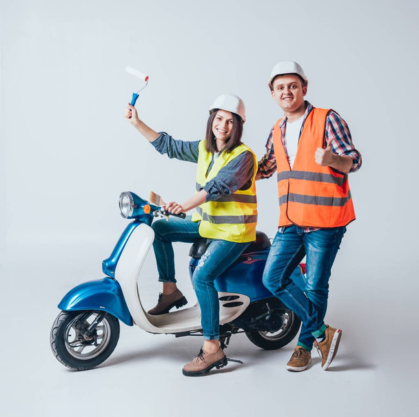 Happy young couple on motorbike with tools. Shopping for construction and repair of new home concept - Photo, Image