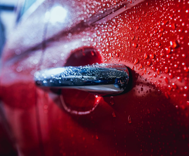Details of electric car. Door handle and rain drops. Red color. - Fotografie, Obrázek