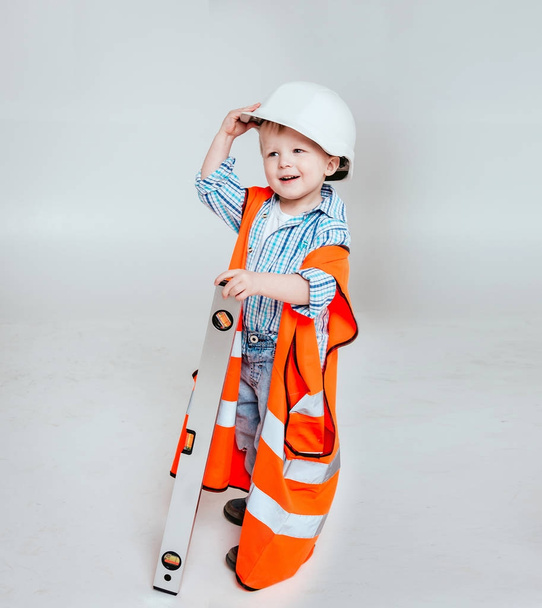 Little boy on the white background. Construction, repair, interior. - Photo, Image