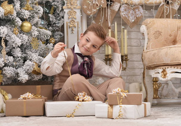 Portrait of little boy  near Christmas tree - Фото, изображение