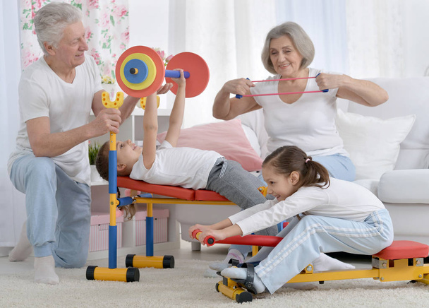 abuelos y nietas haciendo ejercicios en casa
 - Foto, imagen