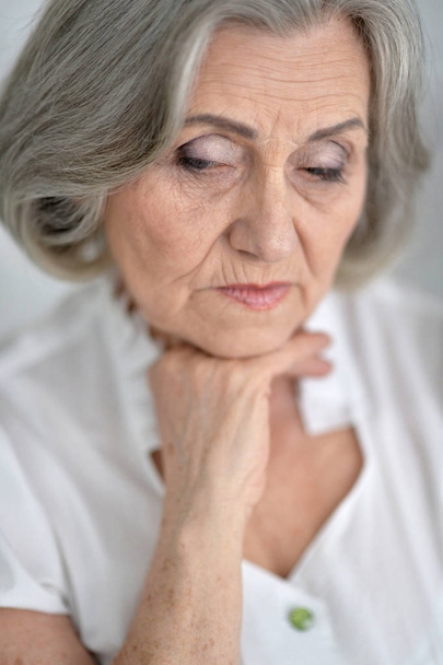 Portrait of a beautiful sad elderly woman close-up - Zdjęcie, obraz