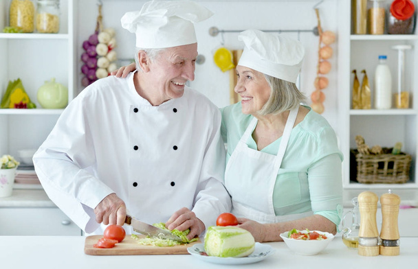 Senior couple at kitchen  cooking    - Фото, изображение