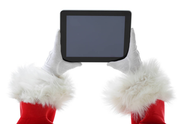 Christmas concept shot with Santa holding a digital tablet, showing it into the camera Isolated on white - Photo, Image