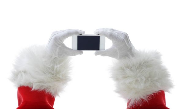 Concetto natalizio girato con Babbo Natale in possesso di uno smart phone bianco isolato su bianco
 - Foto, immagini