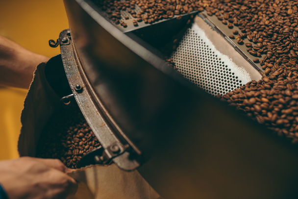 partial view of coffee roaster working on roasting machine - Foto, immagini