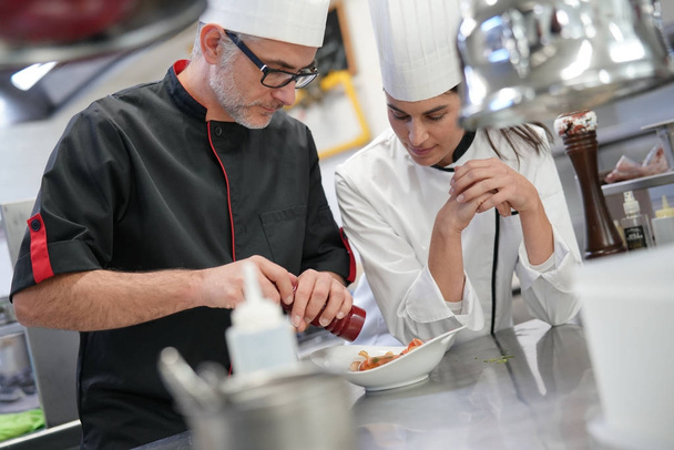 Professional cook chefs in kitchen improving dish composition - Φωτογραφία, εικόνα