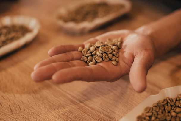 selective focus of man holding coffee beans in hand - Foto, Imagem