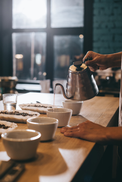 selective focus of man pouring hot water into bowl with grind coffee - Photo, Image