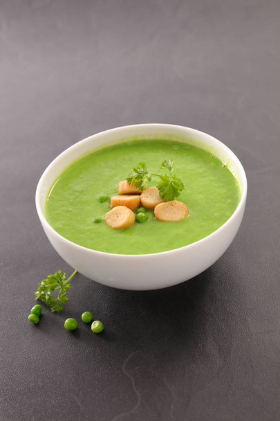 green soup in a white bowl, close up view - Photo, image
