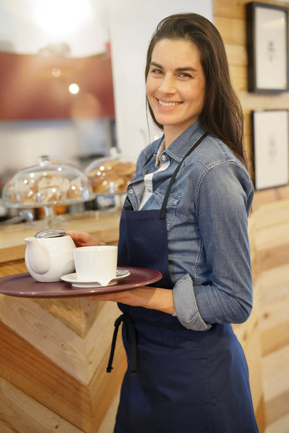 Waitress in coffee shop holding tray - Fotó, kép