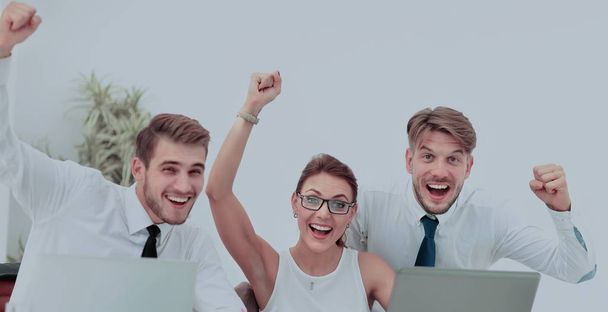 Team of three work colleagues with their arms raised in celebrat - Фото, зображення