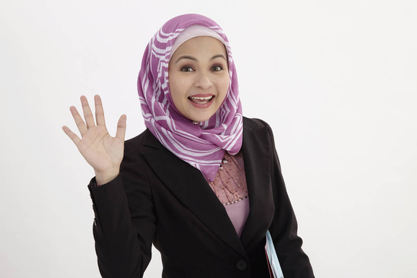 malay woman wearing  business suit holding document files waving hand - Foto, Imagen