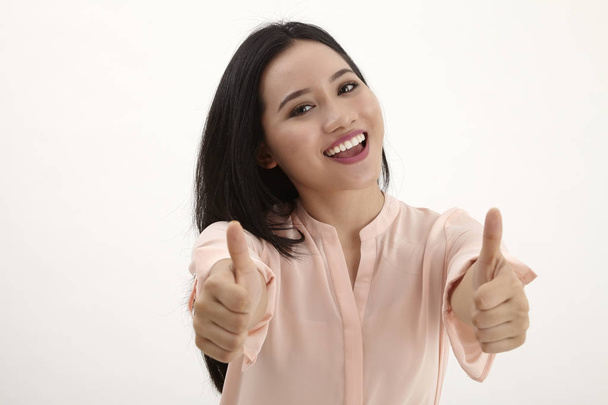  portrait of beautiful young success woman giving thumbs up standing in full length on white background - Photo, image
