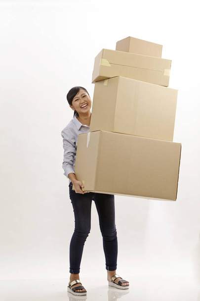 asian woman carrying stack of boxes - Photo, image