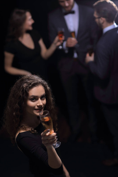 stylish young woman with glass of champagne - Фото, изображение