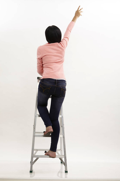 malay climb up on the ladder on the white background - Photo, Image