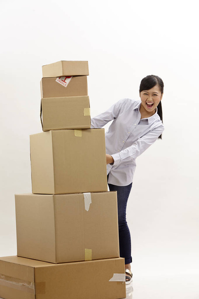 asian woman with stack of boxes on the white background - Fotó, kép