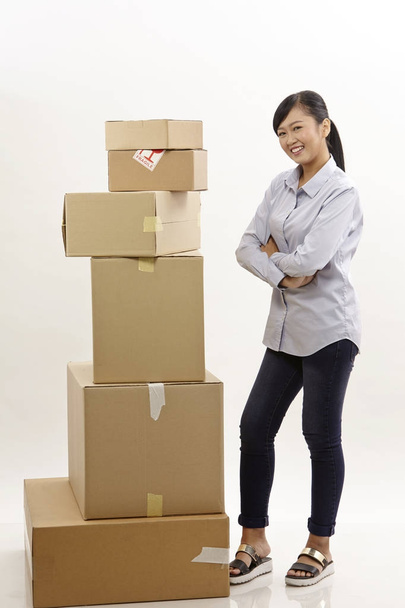 asian woman with stack of boxes on the white background - Foto, afbeelding
