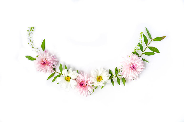 Semicircle Frame of chamomiles, branches, leaves and lilac petals on white background. Flat lay, top view - Foto, imagen