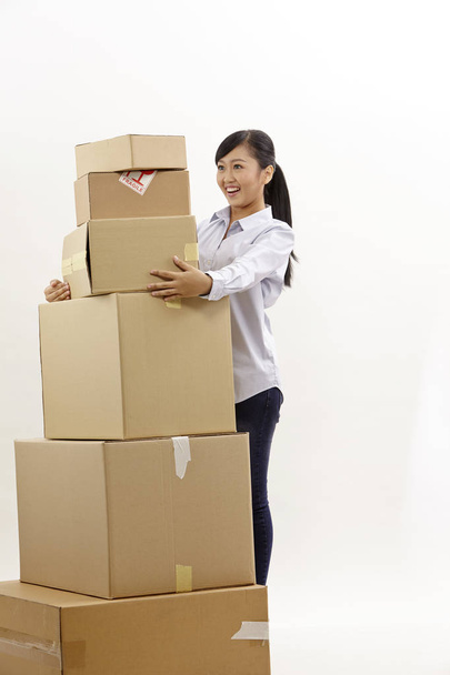 asian woman with stack of boxes on the white background - Foto, Imagen