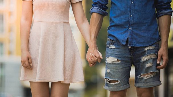 Boyfriend and girlfriend holding each other by hand on date, couple in love - Photo, Image