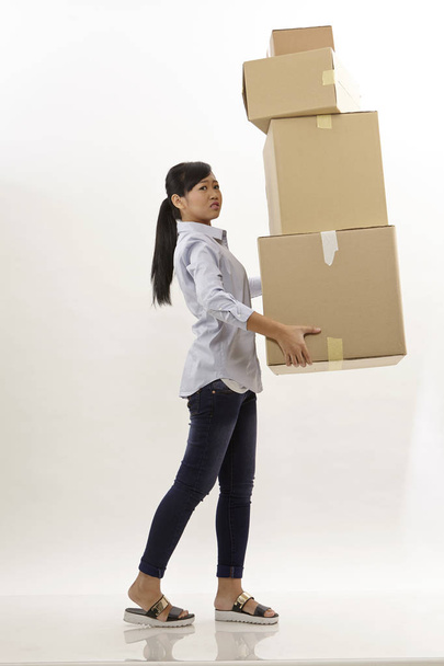 asian woman carrying stack of boxes - Valokuva, kuva