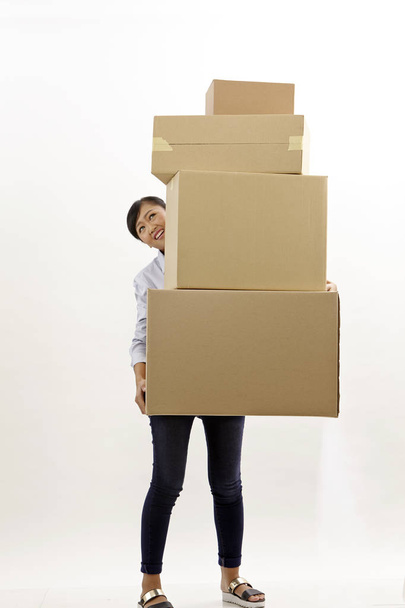 asian woman carrying stack of boxes - 写真・画像