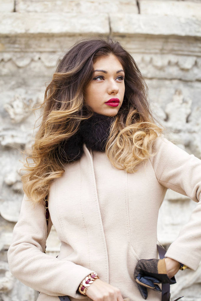 Young beautiful woman in beige coat  - Photo, image