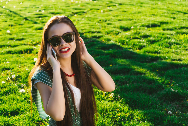 Happy smiling woman use mobile,summer grass background - Fotoğraf, Görsel