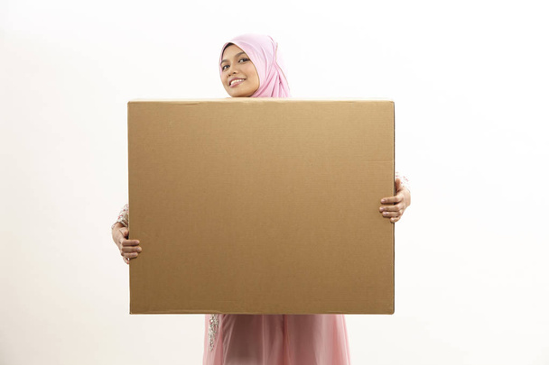 malay woman with tudung holding brown box on white background - Photo, image