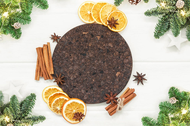 Ingredients for Mulled wine recipe. Orange, cinnamon sticks, anise, and fir branches. Christmas motive. Top view, copy space - Foto, afbeelding