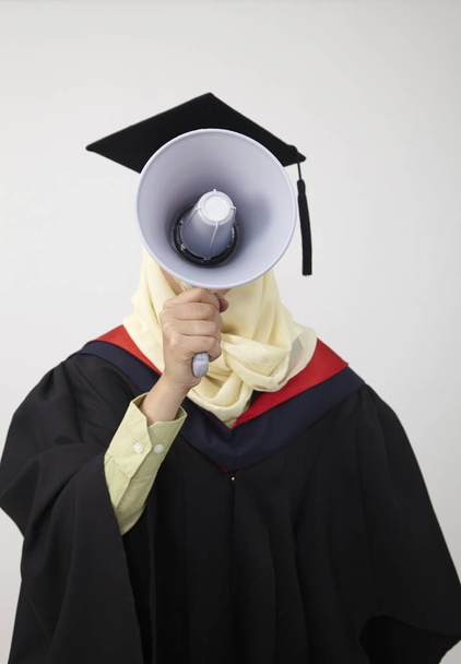 Graduation student shouting through megaphone face covered - Photo, Image