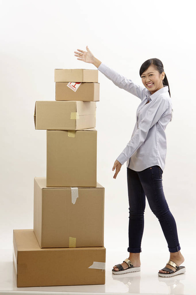asian woman with stack of boxes on the white background - Fotografie, Obrázek