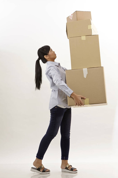 asian woman carrying stack of boxes - Photo, image