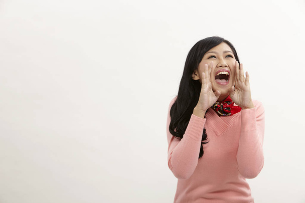 asian woman shouting on the white background - 写真・画像